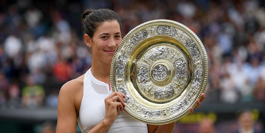 Garbine Muguruza holds aloft the Venus Rosewater Dish after beating Venus Williams 7-5 6-0 to win the Wimbledon title; Getty Images