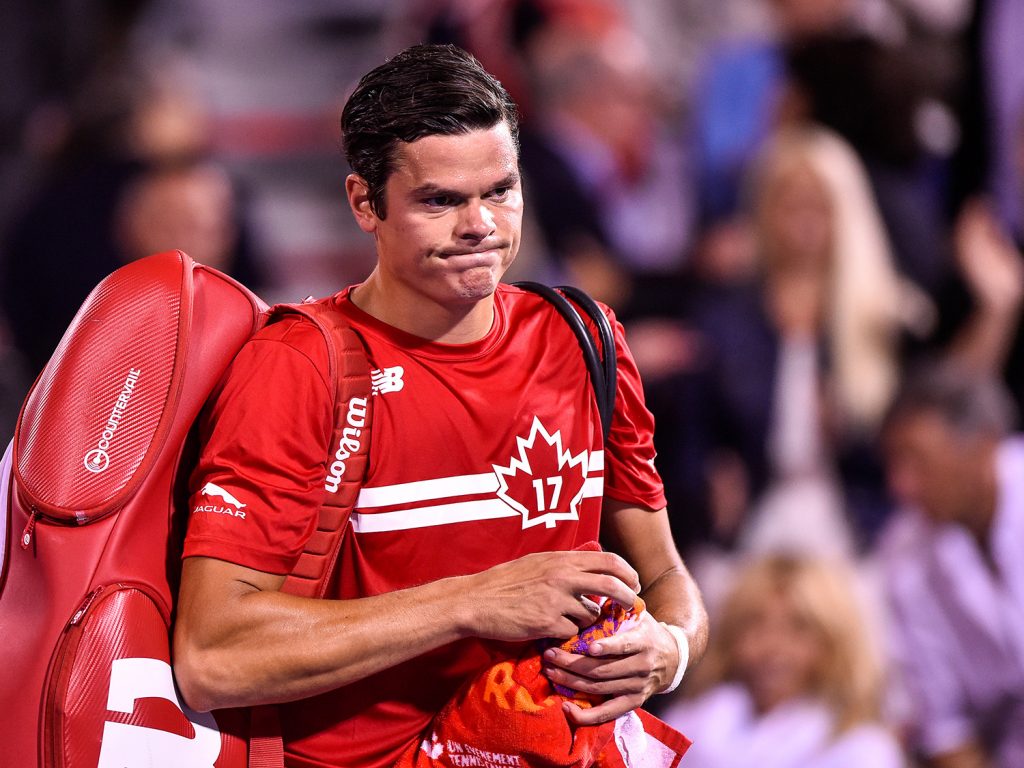 Milos Raonic cut a dejected figure as he was bundled out 6-4 6-4 by Adrian Mannarino. Photo: Getty Images