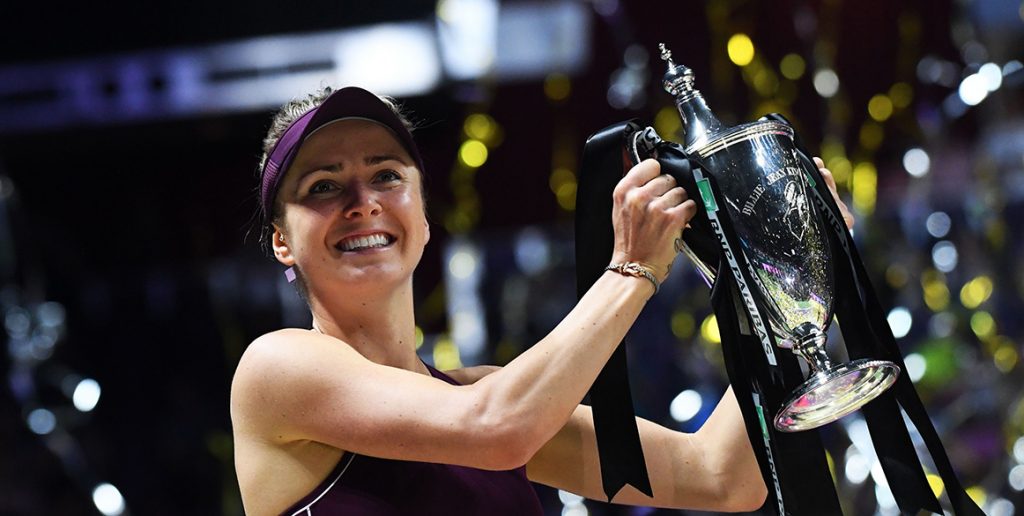 Elina Svitolina poses with the champion's trophy after winning the WTA Finals in Singapore; Getty Images