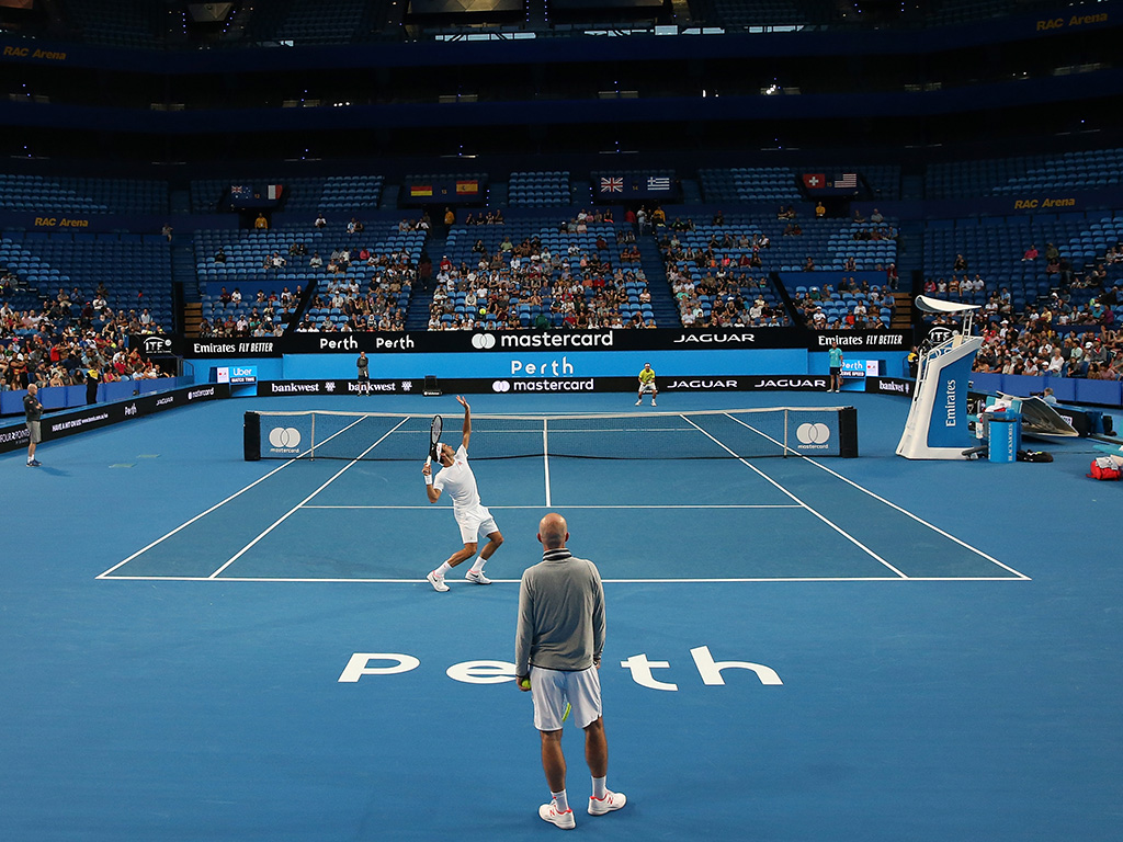 Roger Federer (near court) practices at Perth Arena ahead of the Hopman Cup (Getty Images)